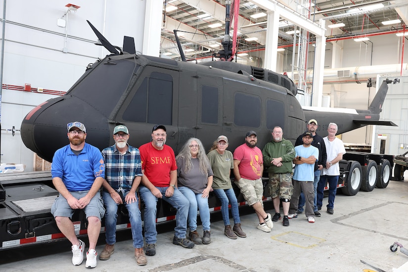 Members of the Letterkenny Army Depot Directorate of Industrial Operations Process Support Division pose in front of a completely repainted Vietnam era UH-1 Iroquois ‘Huey’ helicopter at the depot on Nov. 17, 2024. LEAD team members worked together to provide support to Fort Indiantown Gap’s static display area. Along with the Huey, artisans completed on-site paint repair on two other aircrafts, an AH-1 Cobra and an OH-6 Cayuse, also known as a Loach. (U.S. Army photo by Pam Goodhart)