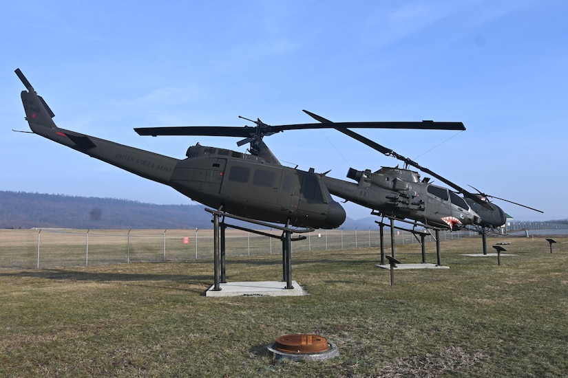 Letterkenny Army Depot in Chambersburg, Pa., recently completed a restoration of a Vietnam era UH-1 Iroquois "Huey" helicopter (foreground) that is on display at Fort Indiantown Gap. Along with the Huey, Letterkenny employees also completed on-site paint repair on two other helicopters on display, an AH-1 Cobra and an OH-6 Cayuse, also known as a Loach. (Pennsylvania National Guard photo by Brad Rhen)