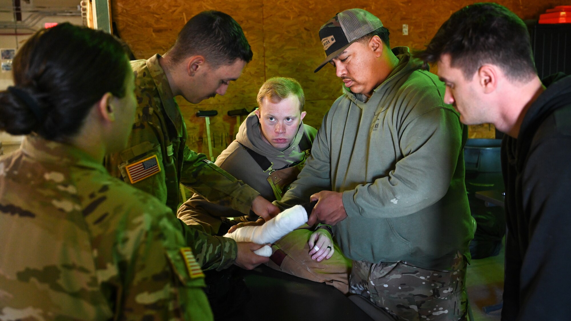 U.S. Air Force Airmen assigned to the 7th Security Forces Squadron at Dyess Air Force Base, Texas, and the 17th SFS at Goodfellow AFB, Texas, practice dressing wounds with U.S. Army Soldiers stationed at Fort Cavazos, Texas, during a K-9 medical training event at Dyess Air Force Base, Texas, Dec. 18, 2024. The event turned an annual training requirement into an opportunity to connect with civilian law enforcement agencies. (U.S. Air Force photo by Airman 1st Class Jade M. Caldwell)