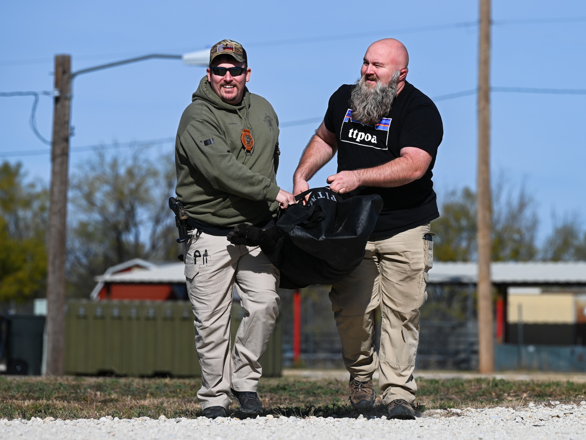 Law enforcement from Taylor County Sheriff's Department carry a military working dog trauma mannequin during a U.S. Army led K-9 medical training event at Dyess Air Force Base, Texas, Dec. 18, 2024. This exercise simulated a K-9 in need of medical evacuation, where law enforcement would have to assess, treat and report their findings to medical personnel. (U.S. Air Force photo by Airman 1st Class Jade M. Caldwell)