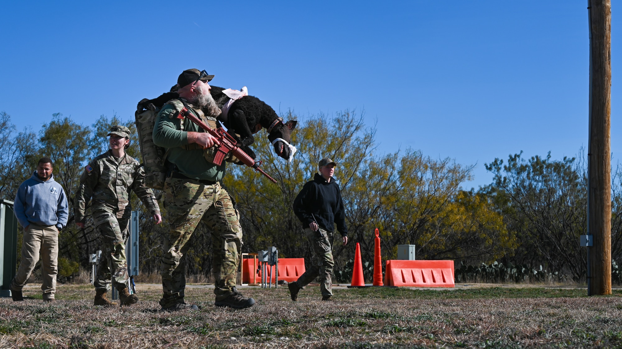 Law enforcement from Taylor County Sheriff's Department participate in a tactical combat casualty care exercise during a U.S. Army led K-9 medical training event at Dyess Air Force Base, Texas, Dec. 19, 2024. After two days of classroom instruction, this culminating exercise put participants through a high pressure combat scenario where they would have to stabilize, evacuate and treat an injured K-9. (U.S. Air Force photo by Airman 1st Class Jade M. Caldwell)