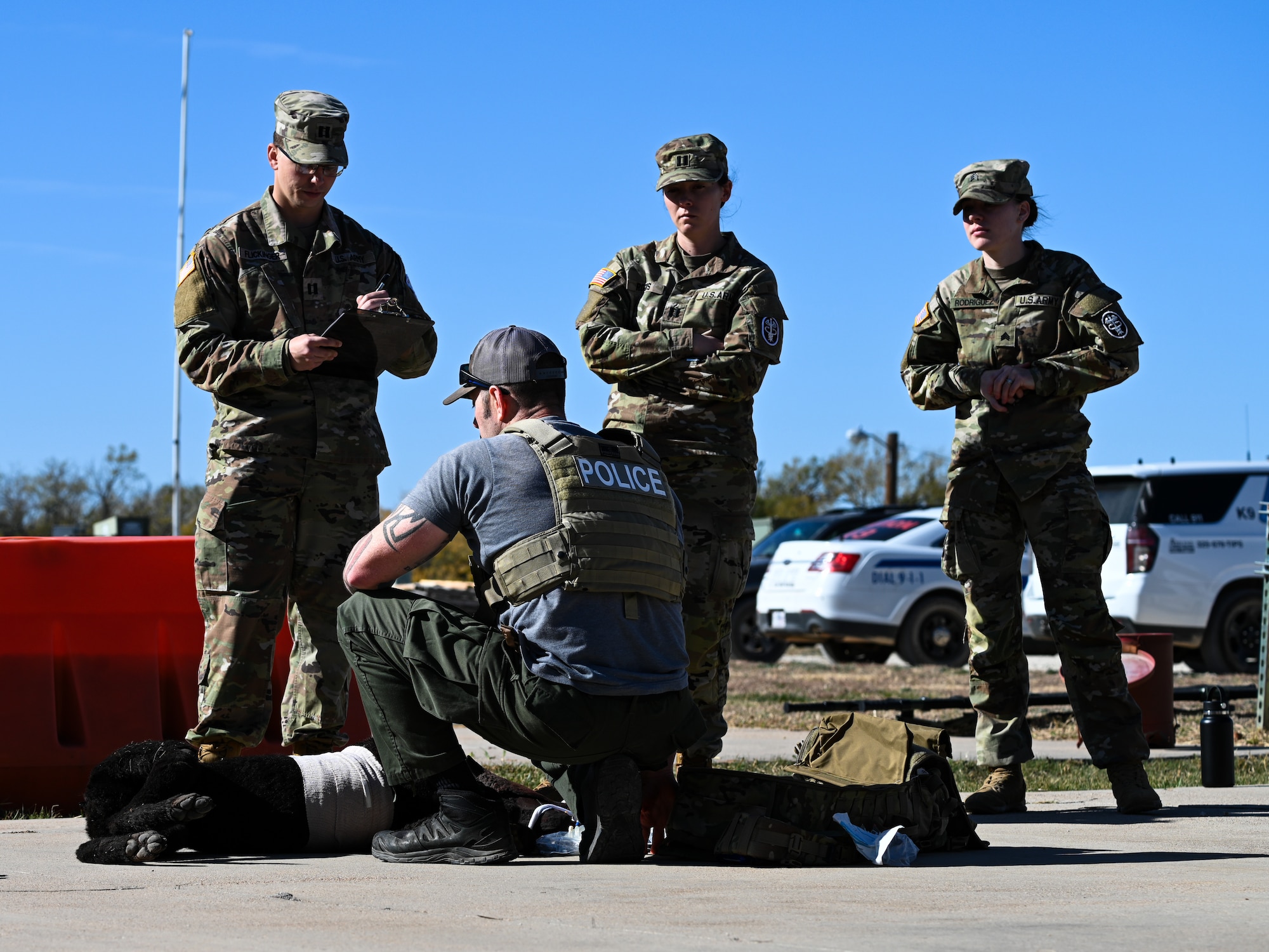 Law enforcement officials from the Abilene Police Department train with U.S. Army Soldiers stationed at Fort Cavazos, Texas, during a K-9 medical training event at Dyess Air Force Base, Texas, Dec. 19, 2024. The training event connected civilian and military law enforcement personnel with medical professionals who were able to share their experiences and give guidance when caring for injured K-9s. (U.S. Air Force photo by Airman 1st Class Jade M. Caldwell)