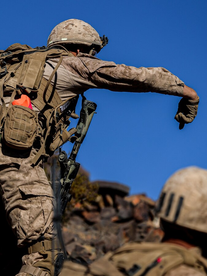 U.S. Marine Corps Cpl. Matthew Roderick commands his squad to take cover during a platoon supported urban raid during the adversary force exercise at Marine Corps Air-Ground Combat Center, Twentynine Palms, California, Dec. 6, 2024. Roderick is a squad leader from Provo, Utah. The AFX is the primary readiness-building event prior to Echo Company, 2nd Battalion, 23rd Marine Regiment’s upcoming deployment to Okinawa, Japan, in support of the Marine Corps’ Unit Deployment Program. The exercise serves as an opportunity to receive training across all warfighting functions in a realistic and fully resourced environment. (U.S. Marine Corps photo by Lance Cpl. Orion Stpierre)