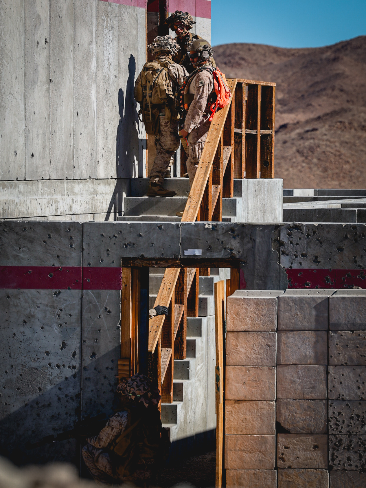 U.S. Marines clear a building as part of a company supported urban attack during an adversary force exercise at Marine Corps Air-Ground Combat Center, Twentynine Palms, California, Dec. 10, 2024. Marines with Golf Company, 2nd Battalion, 23rd Marine Regiment, 4th Marine Division, conducted the training event to increase proficiency in combat operations in an urban environment in preparation for their upcoming deployment to Okinawa, Japan, ensuring the Marines are fully manned, trained and equipped to meet mission challenges. (U.S. Marine Corps photo by Lance Cpl. Orion Stpierre)