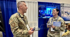 Two Airmen talking to one another.