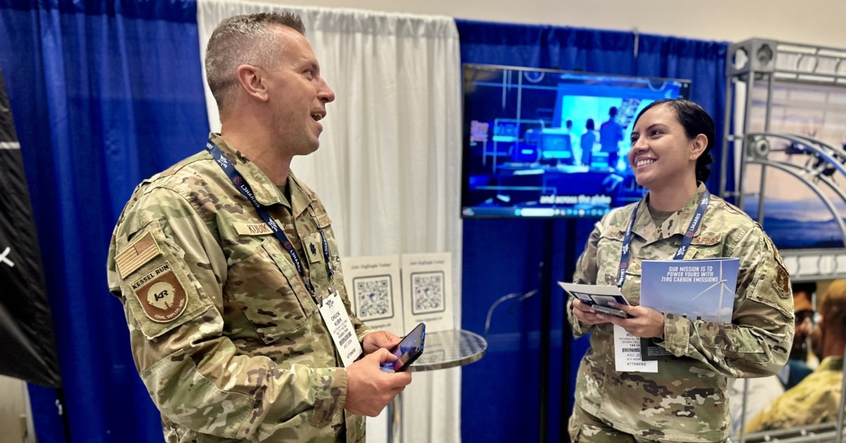 Two Airmen talking to one another.