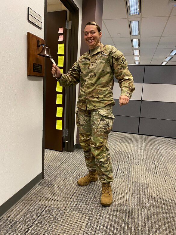 1st Lt. Leandra Ramos, project manager, Fort Worth District's Programs and Project Management Division, rings the bell to signify all her Fiscal Year 2024 contracting tasks have been completed successfully.