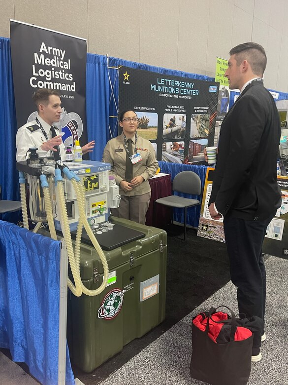 Sgt. Nick McKinley, left, and Staff Sgt. Nora Martinez from the U.S. Army Medical Materiel Agency’s Medical Maintenance Operations Division at Hill Air Force Base, Utah, talk with an attendee during the 2024 DOD Maintenance Symposium, held Dec. 10-13 at the Salt Palace Convention Center in Salt Lake City.