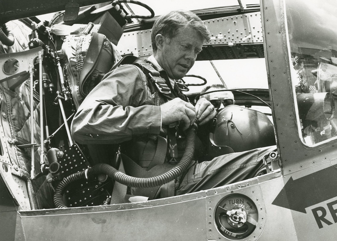 A government official performs a flight check aboard an aircraft.