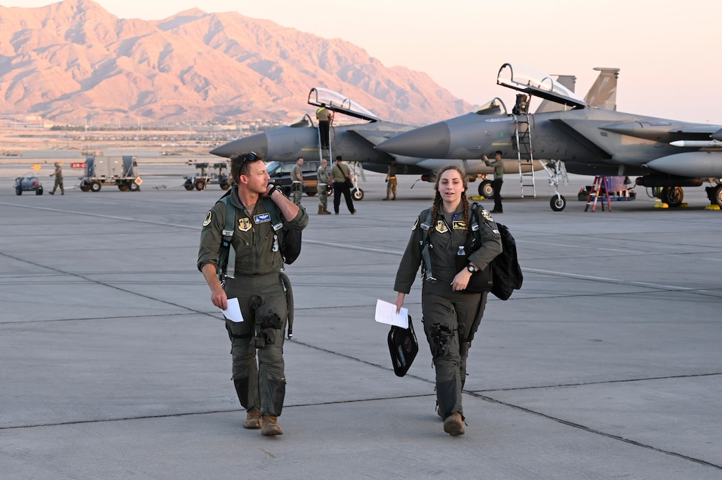 U.S. Air Force Lt. Col. James Hasting and Capt. Annalisa Sanfilippo, 194th Fighter Squadron pilots, exit the flightline after landing at Nellis Air Force Base, Nevada, Sept. 11, 2024.