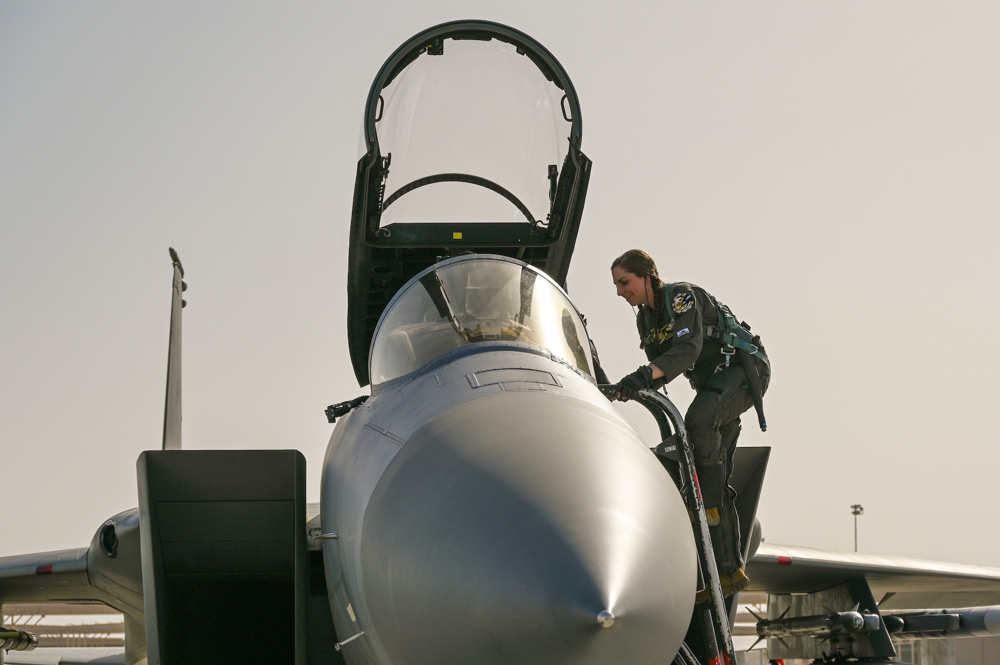 U.S. Air Force Capt. Annalisa Sanfilipo, 194th Fighter Squadron pilot, enters the cockpit of an F-15C Aircraft, Sept. 12, 2024, at Nellis Air Force Base, Nevada.