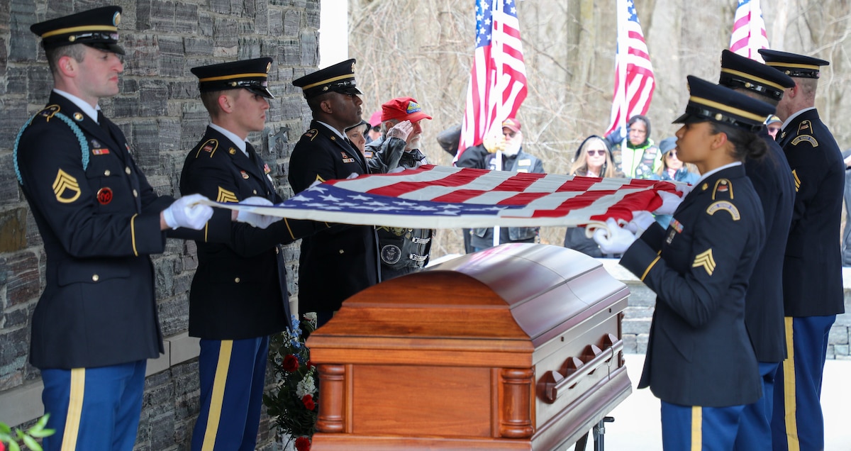 Soldiers assigned to the New York Army National Guard Honor Guard prepare to fold the American flag over the casket of Chief Warrant Officer 2 Casey Frankosk at the Gerald B. Solomon Saratoga National Cemetery in Schuylerville, New York, March 22, 2024. Frankoski, a helicopter pilot, died March 8 outside Rio Grande City, Texas, while patrolling the Southwest Border.