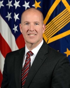 Mr. Harding in front of the American flag and the SES two star flag for his official portrait