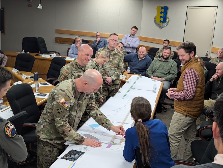 Col. Robert Newbauer, U.S. Army Corps of Engineers, Omaha District commander, makes notations on a map as Col. Derek Oakley, 28th Bomb Wing commander, looks on as they lead a rehearsal of concept drill at Ellsworth Air Force Base, S.D., Dec. 3, 2024. The exercise focused on planning the temporary relocation of B-1B Lancer bombers and personnel to Grand Forks Air Force Base, N.D., as part of a $129.5 million runway replacement project. (U.S. Army photo by Andrew Nystrom)