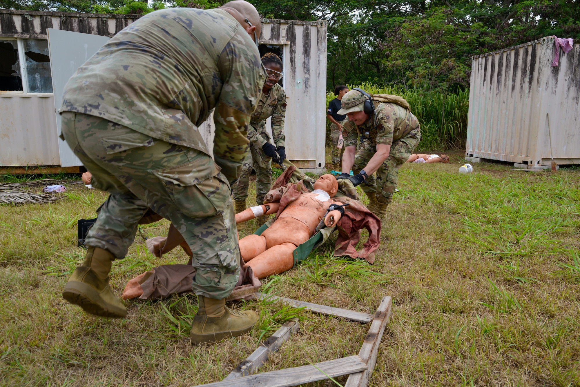 Staff Sgt. Jacob Price, Senior Airman Atinuke Aiyenigba, and Captain Ralph Garcia transfer a simulated casualty to safety during an exercise at the Medical Simulation Training Center (MSTC) at Schofield Barracks, Oahu, Hawaii, Aug. 27, 2024.