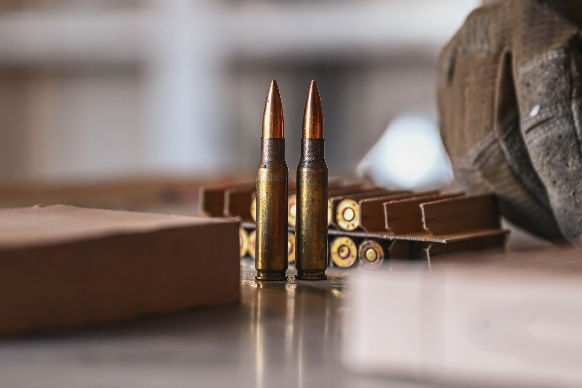 Two bullets sit on a table.