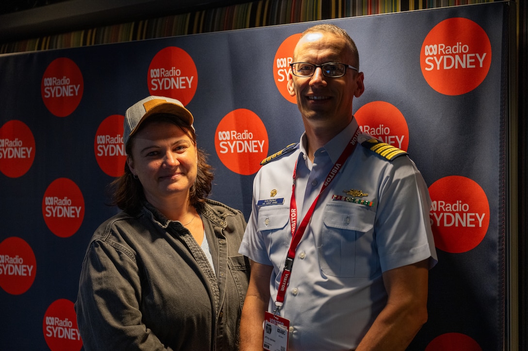 U.S. Coast Guard Capt. Jeffrey Rasnake, commanding officer, U.S. Coast Guard Cutter Polar Star (WAGB 10), stands with a radio host from ABC Radio Sydney after an interview in Sydney, Dec. 23, 2024. The Polar Star stopped in Sydney on its way to Antartica in support of Operation Deep Freeze, a joint service, inter-agency support operation for the National Science Foundation, which manages the United States Antarctic Program.  (U.S. Coast Guard photo by Petty Officer 2nd Class Briana Carter)