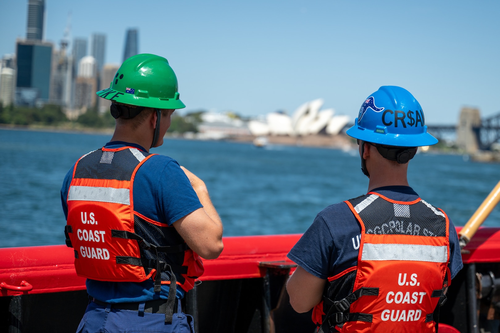 Crewmembers aboard U.S. Coast Guard Cutter Polar Star (WAGB 10) look out over Sydney Harbor while the Polar Star departs Royal Australian Naval Base HMAS Kuttabul in Sydney, Dec. 27, 2024. The Polar Star stopped in Sydney on its way to Antartica in support of Operation Deep Freeze, a joint service, inter-agency support operation for the National Science Foundation, which manages the United States Antarctic Program.  (U.S. Coast Guard photo by Petty Officer 2nd Class Briana Carter)