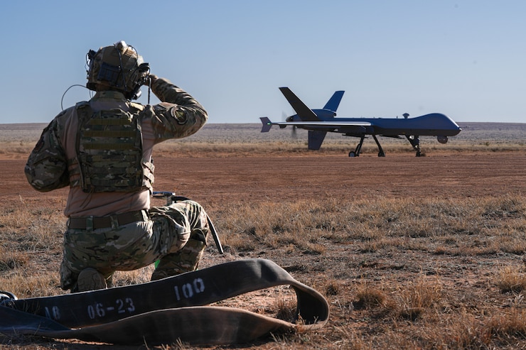 A U.S. Air Force Airman assigned to the 1st Special Operations Support Squadron Mission Sustainment Team prepares to refuel an MQ-9 Reaper at Melrose Air Force Range, New Mexico, Dec. 16, 2024. Exercise Reaper Castillo validated the MQ-9’s ability to conduct key operations in austere environments, including dirt-strip landings, refueling, rearming and rapid relaunch. (U.S. Air Force photo by Airman 1st Class Gracelyn Hess)