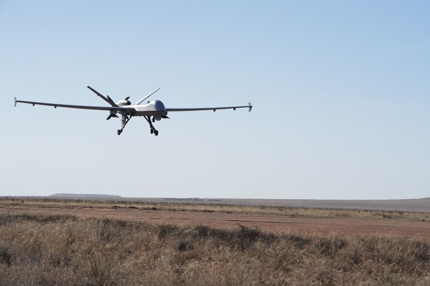 An MQ-9 Reaper prepares to land on a dirt strip