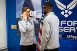 Maj. Micah D. Bluto, 351st Recruiting Squadron commander, conducts the Oath of Enlistment with Trakeius Battle, a new recruit, at the Duluth, Georgia, recruiting office.