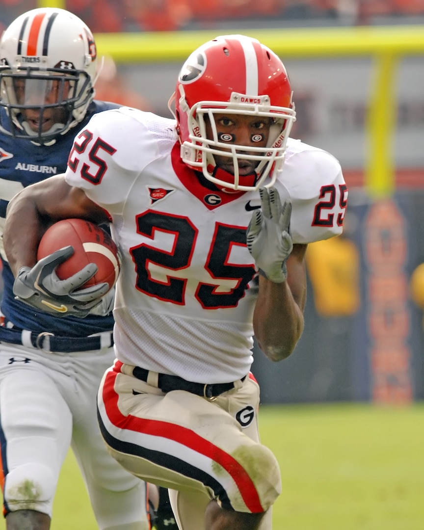 Trakeius Battle, a former football player with the University of Georgia, runs the football down the field during a game against the Auburn University.