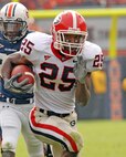 Trakeius Battle, a former football player with the University of Georgia, runs the football down the field during a game against the Auburn University.