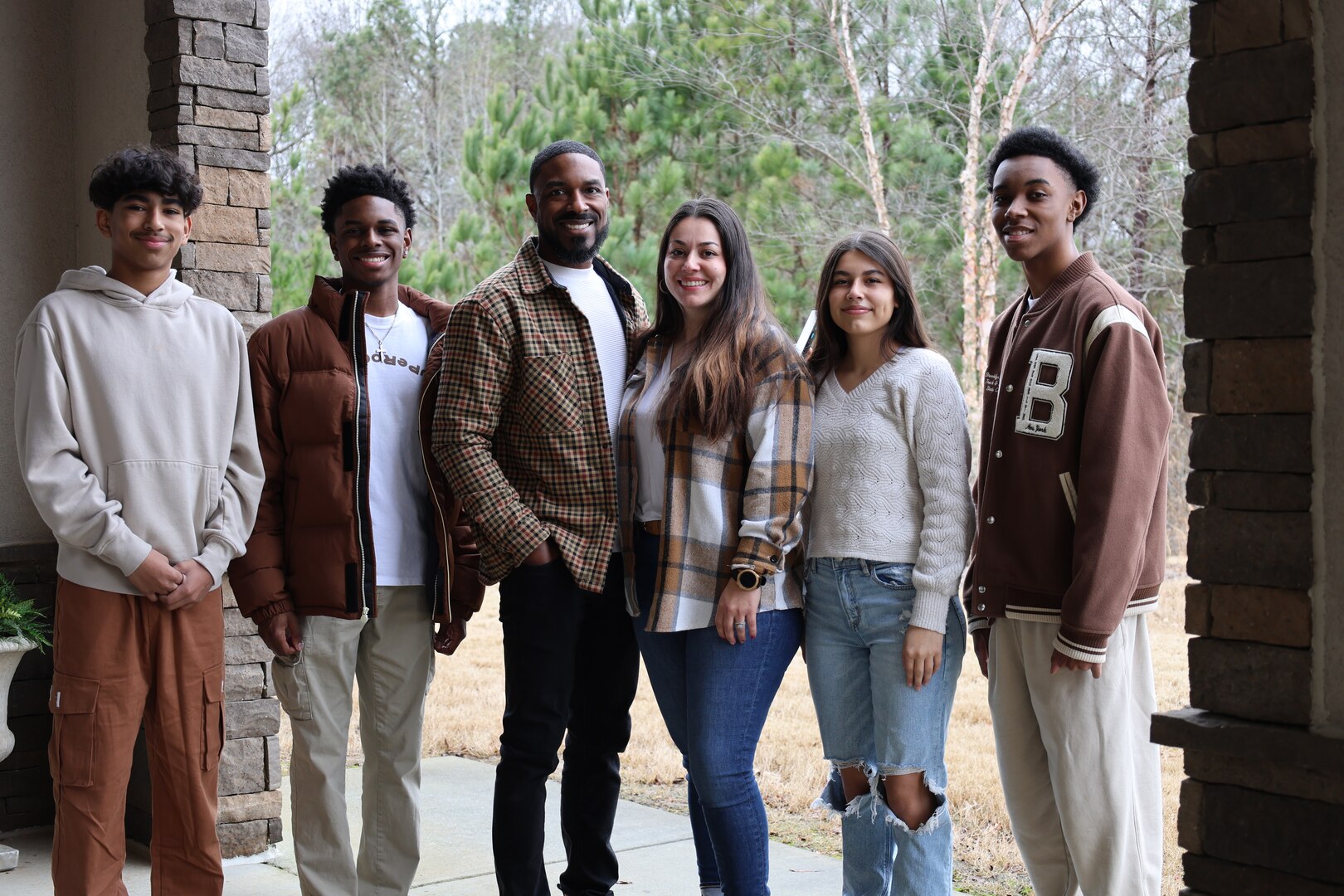 Trakeius Battle, center, a former National Football League player with the San Diego Chargers and Dallas Cowboys, poses with his family.