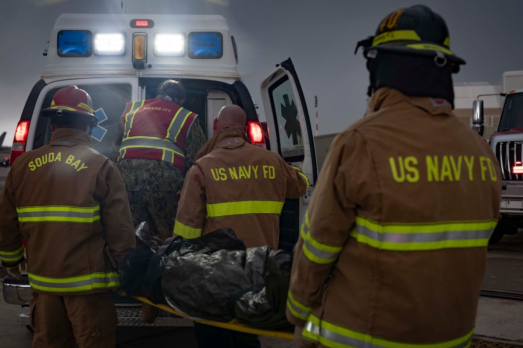 Firefighters assigned to Naval Support Activity Souda Bay Fire & Emergency Services simulate a casualty evacuation during an earthquake response drill on Jan. 30, 2024.