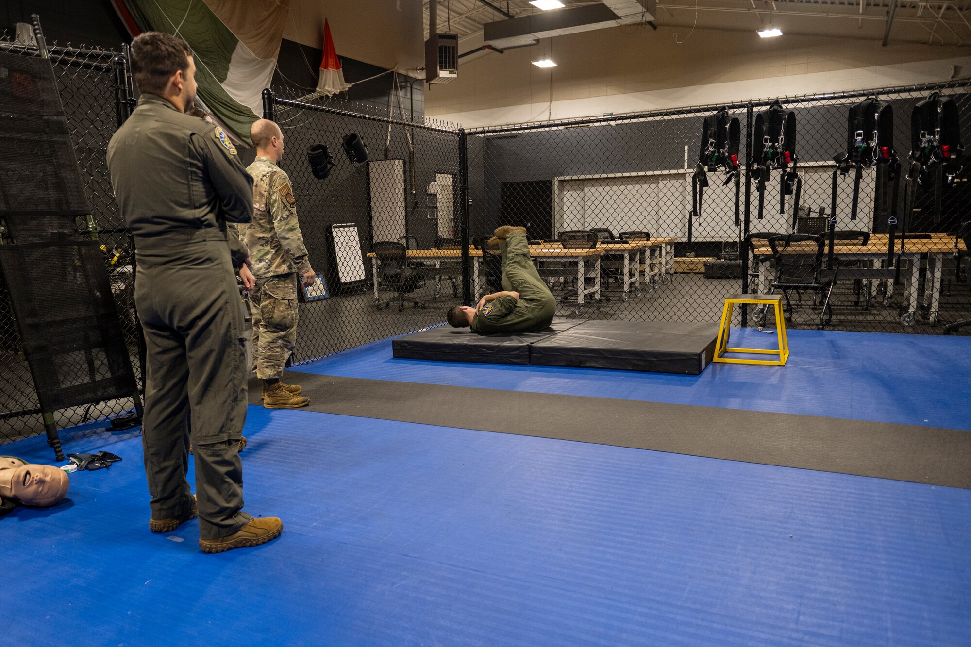 Airman practices parachute landing in simulation