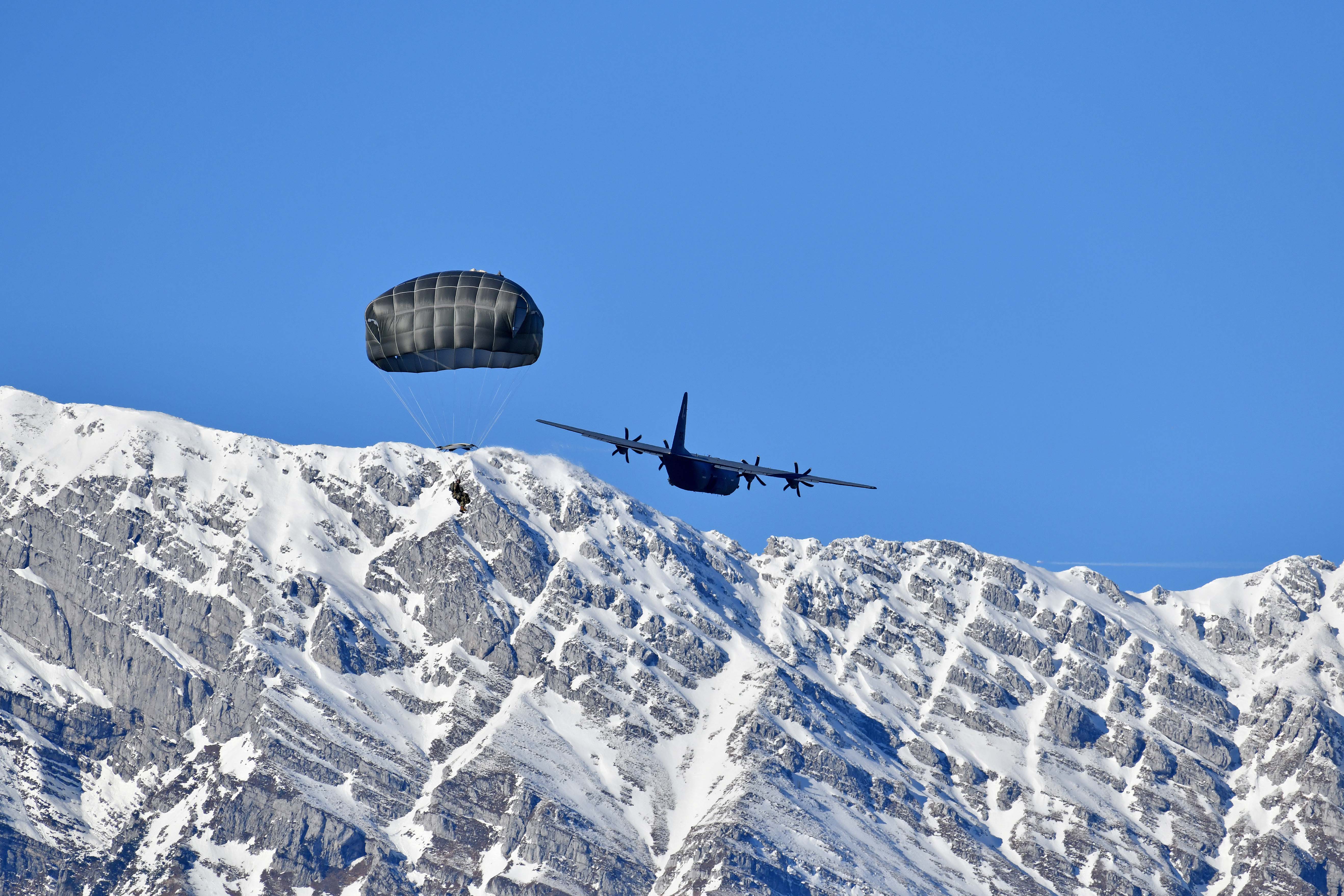 U.S. paratroopers jump from a C-130 Hercules aircraft over Juliet