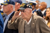 A photo of a man saluting.