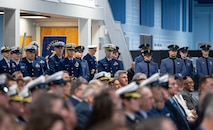 A photo of the audience watching the presentation.