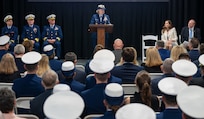 A photo of a woman speaking on stage.