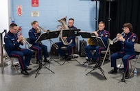 A photo of U.S. Coast Guard Band members playing their instruments.