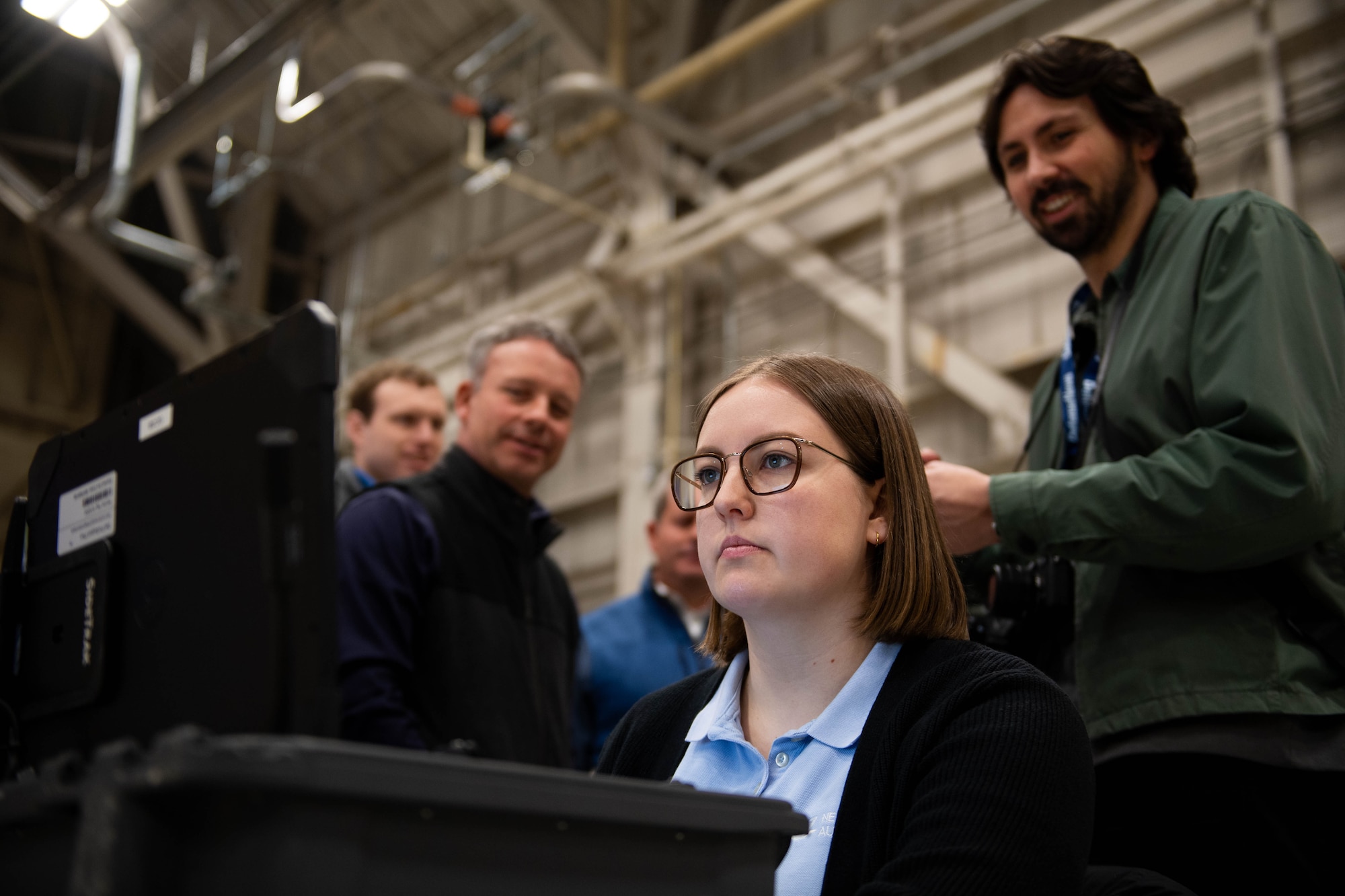 Sophie LeGore, Near Earth Autonomy test engineer, prepares for a drone demonstration as media looks on at Dover Air Force Base, Delaware, January 23, 2024. Team Dover in cooperation with Boeing and Near Earth Autonomy tested a drone program for an autonomous C-5M Super Galaxy aircraft inspection project. Traditional inspections that require personnel to use a safety harness, maintenance stands, or vehicles can take hours to accomplish, but the drone can complete the same inspection in approximately 10 minutes. (U.S. Air Force photo by Tech. Sgt. J.D. Strong II)