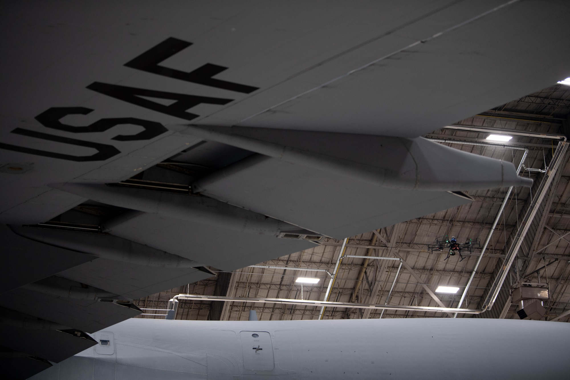 A Near Earth Autonomy drone scans for anomalies such as stress fractures, rust, and loose bolts on a C-5M Super Galaxy at Dover Air Force Base, Delaware, January 23, 2024. Team Dover in cooperation with Boeing and Near Earth Autonomy tested a drone program for an autonomous C-5M Super Galaxy aircraft inspection project. Traditional inspections that require personnel to use a safety harness, maintenance stands, or vehicles can take hours to accomplish, but the drone can complete the same inspection in approximately 10 minutes. (U.S. Air Force photo by Tech. Sgt. J.D. Strong II)