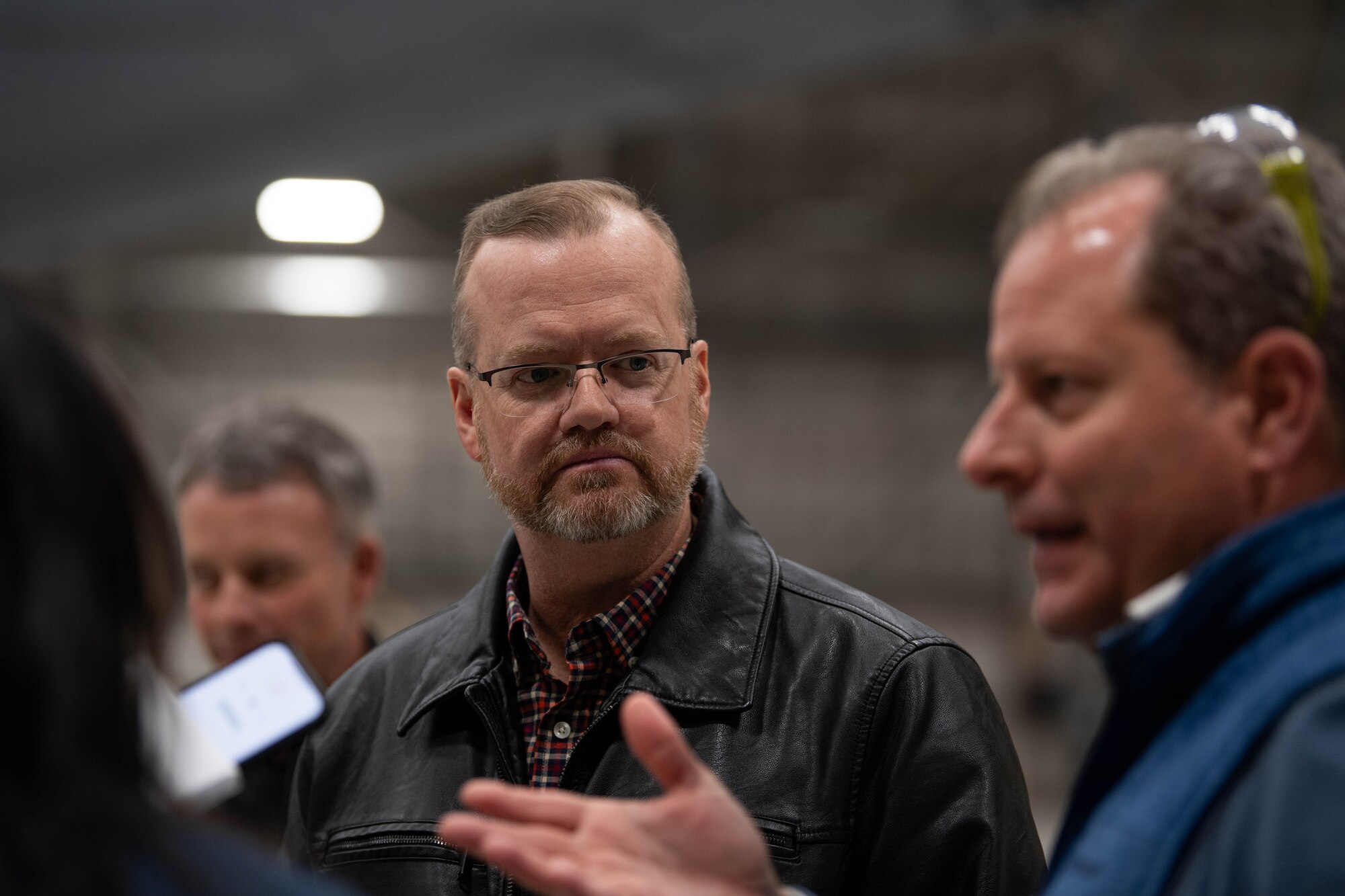 Ken Jones, 436th Mission Generation Group continuous process improvement manager, listens to an interview at Dover Air Force Base, Delaware, January 23, 2024. Team Dover in cooperation with Boeing and Near Earth Autonomy tested a drone program for an autonomous C-5M Super Galaxy aircraft inspection project. Traditional inspections that require personnel to use a safety harness, maintenance stands, or vehicles can take hours to accomplish, but the drone can complete the same inspection in approximately 10 minutes. (U.S. Air Force photo by Tech. Sgt. J.D. Strong II)