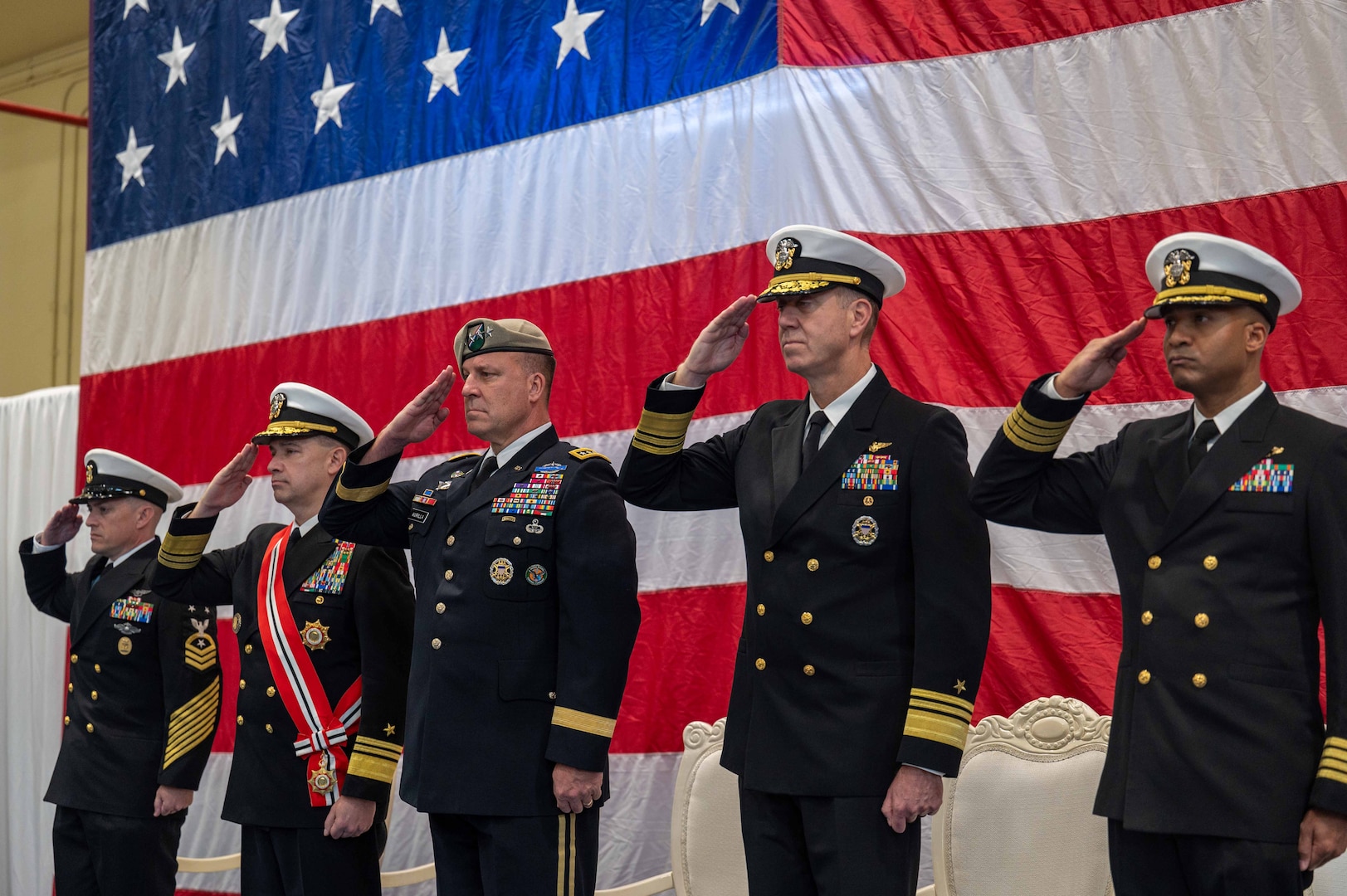 MANAMA, Bahrain (Feb. 1, 2024) Army Gen. Michael Erik Kurilla, commander of U.S. Central Command, center; Vice Adm. Brad Cooper, outgoing commander of U.S. Naval Forces Central Command (NAVCENT), U.S. 5th Fleet and Combined Maritime Forces (CMF), left; and Vice Adm. George Wikoff, incoming commander of NAVCENT, U.S. 5th Fleet and CMF, right; render honors during a change of command ceremony in Manama, Bahrain, Feb. 1. NAVCENT and U.S. 5th Fleet’s area of operations encompasses about 2.5 million square miles of water area and includes the Arabian Gulf, Red Sea, Gulf of Oman and parts of the Indian Ocean. This expanse, comprised of 21 countries, includes three critical choke points at the Strait of Hormuz, the Suez Canal and the Bab al-Mandeb at the southern tip of Yemen. (U.S. Navy photo)