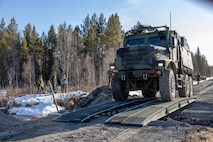 U.S. Marines with 2d Combat Engineer Battalion, 2d Marine Division, cross a gap with a viper bridge during viper bridge training near Ostersund, Sweden, April 17, 2023. Marines are deployed to Norway as part of Marine Rotational Forces Europe 23.1 which focuses on regional engagements throughout Europe by conducting various exercises, arctic cold-weather and mountain warfare training, and military-to-military engagements, which enhance overall interoperability of the U.S. Marine Corps with allies and partners. (U.S. Marine Corps photo by Sgt. Christian M. Garcia)