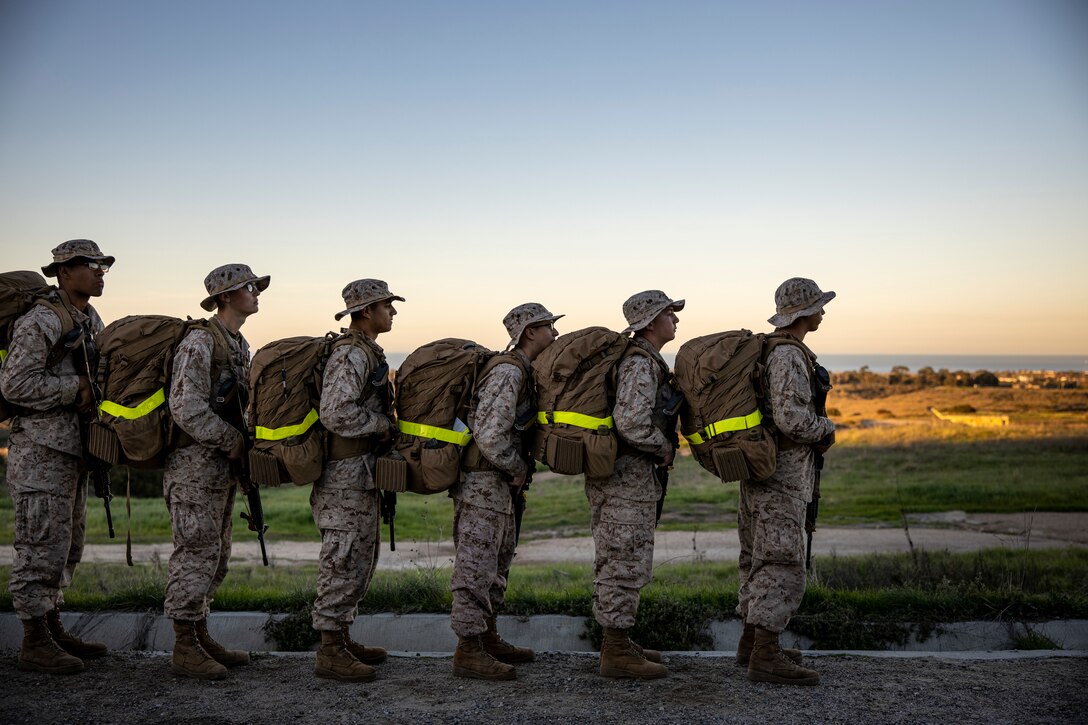 U.S. Marine Corps recruits with Delta Company, 1st Recruit Training Battalion, prepare to conduct the second half of an 8-kilometer hike at Marine Corps Base Camp Pendleton, California, Jan. 30, 2024. The purpose of the hike is to condition the recruits to rigorous terrain on Camp Pendleton in preparation for their 13-kilometer hike and culminating event -- the Crucible. (U.S. Marine Corps photo by Sgt. Yvonna Guyette)