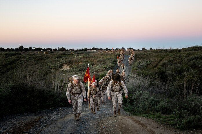 U.S. Marine Corps recruits with Delta Company, 1st Recruit Training Battalion, conduct an 8-kilometer hike at Marine Corps Base Camp Pendleton, California, Jan. 30, 2024. The purpose of the hike is to condition the recruits to rigorous terrain on Camp Pendleton in preparation for their 13-kilometer hike and culminating event -- the Crucible. (U.S. Marine Corps photo by Sgt. Yvonna Guyette)