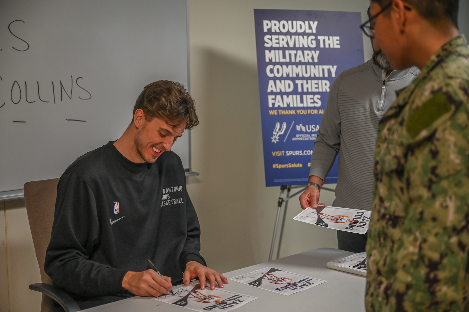Zach Collins, San Antonio Spurs player, signs autographs for students, staff and instructors while visiting the Medical Education and Training Campus, Joint Base San Antonio-Fort Sam Houston, TX, Jan. 25, 2024.