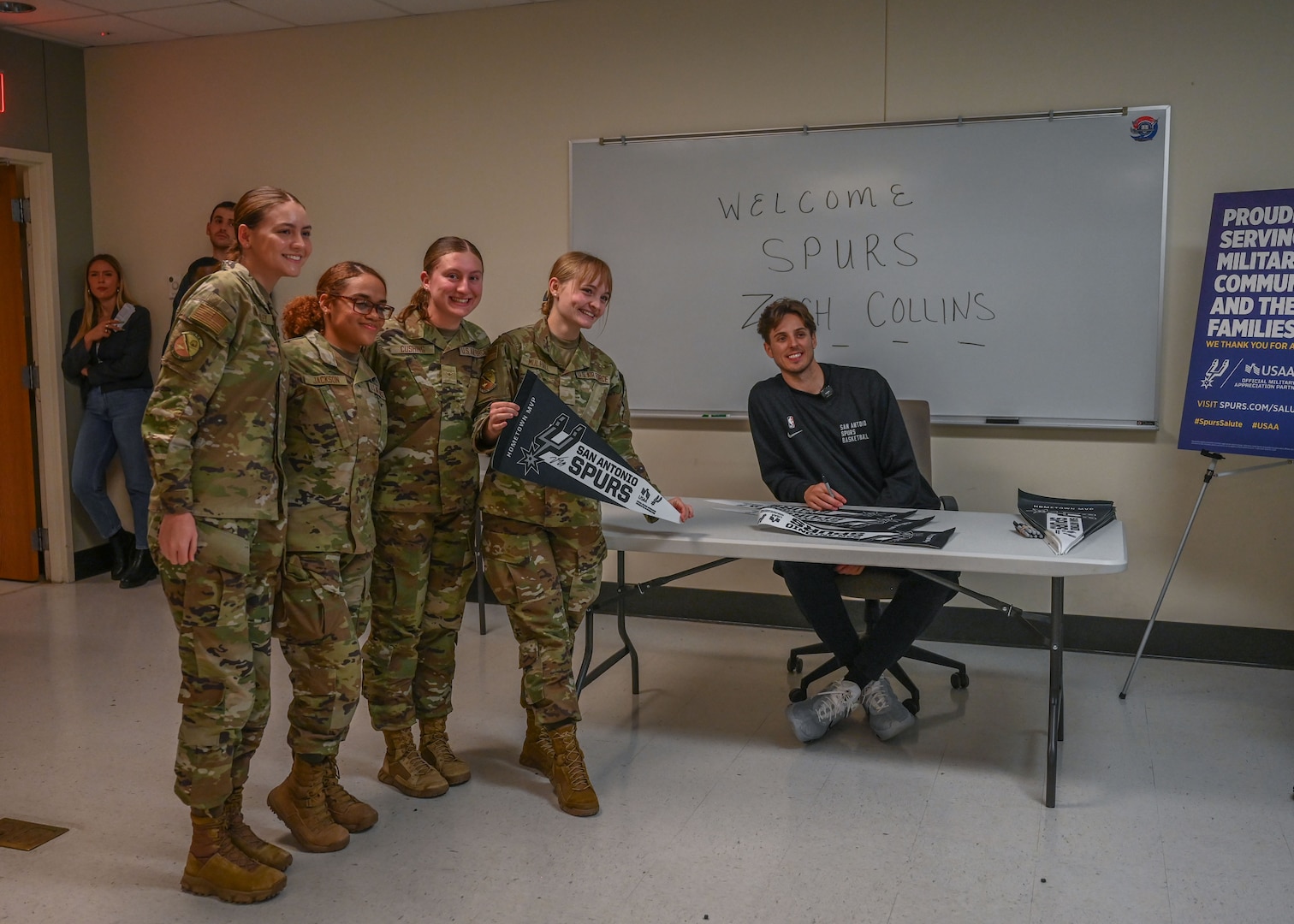 Zach Collins, San Antonio Spurs player, signs autographs for students, staff and instructors while visiting the Medical Education and Training Campus, Joint Base San Antonio-Fort Sam Houston, TX, Jan. 25, 2024.