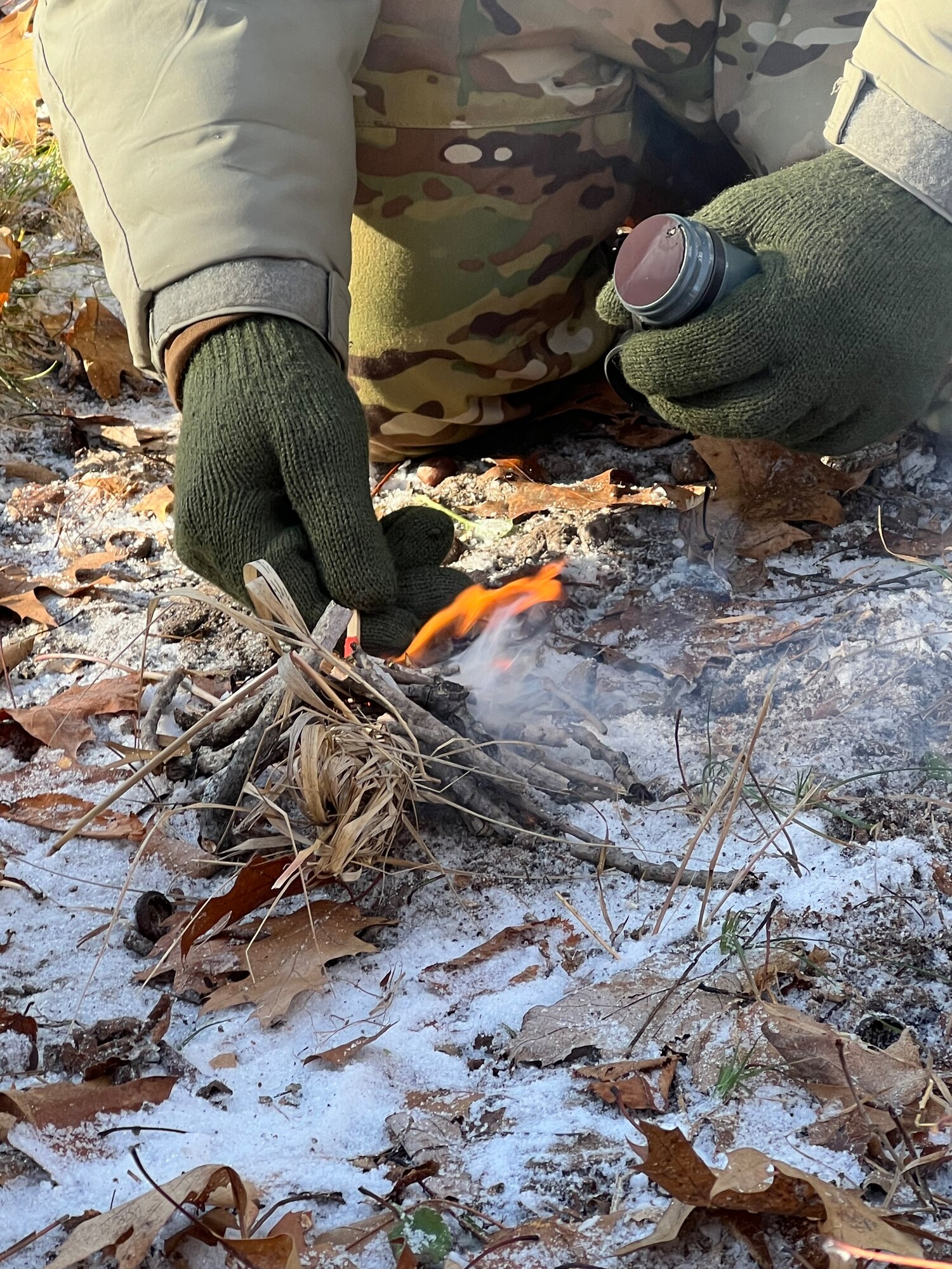 Air National Guard Security Forces specialists build a fire using only matches and materials found in nature in subzero temperatures at Camp Ripley Training Center, Minnesota as part of the Air National Guard's Security Forces Cold Weather Operations Course (CWOC) on January 17, 2024. The two-week CWOC course combined classroom instruction, outdoor skills development, and a 3-day, field training event that required students to build and sleep in arctic tent systems, subsisting on cold weather Meals Ready to Eat and incorporated land navigation, live saving skills, and cold water immersion events. 50 students from Air National Guard wings from across the U.S. participated in the advanced, cold weather survival course planned by personnel assigned to the 148th Fighter Wing, Minnesota Air National Guard. (U.S. Air National Guard photo by Audra Flanagan)