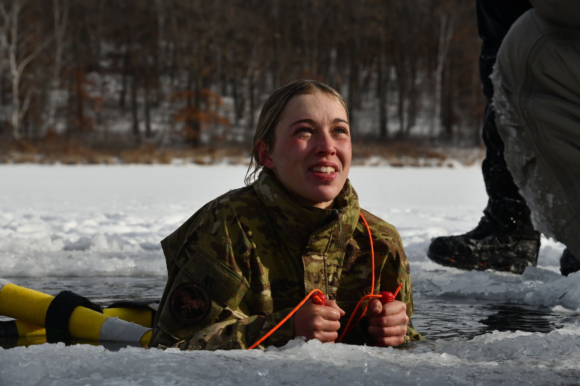 An Air National Guard Security Forces specialist assigned to the 148th Fighter Wing, Minnesota Air National Guard, participates in a cold-water immersion as part of the Air National Guard's Security Forces Cold Weather Operations Course (CWOC) at Camp Ripley Training Center, Minnesota, on January 18, 2024. The two-week CWOC course combined classroom instruction, outdoor skills development, and a 3-day, field training event that required students to build and sleep in arctic tent systems, subsisting on cold weather Meals Ready to Eat and incorporated land navigation, live saving skills, and cold water immersion events. 50 students from Air National Guard wings from across the U.S. participated in the advanced, cold weather survival course planned by personnel assigned to the 148th Fighter Wing, Minnesota Air National Guard. (U.S. Air National Guard photo by Audra Flanagan)