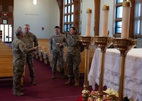 U.S. Air Force Chaplain Maj. Gen. Randall Kitchens, U.S. Air Force chief of chaplains, (center) and U.S. Air Force Chief Master Sgt. Sadie Chambers, Religious Affairs senior enlisted advisor, (right) receives a tour of the Northern Lights Chapel at Minot Air Force Base, North Dakota, Jan. 29, 2024. As the Chief of Chaplains, Kitchens leads the Department of the Air Force Chaplain Corps of approximately 2,100 chaplains and religious affairs Airmen from the active duty and Air Reserve components. (U.S. Air Force photo by Airman 1st Class Luis Gomez)