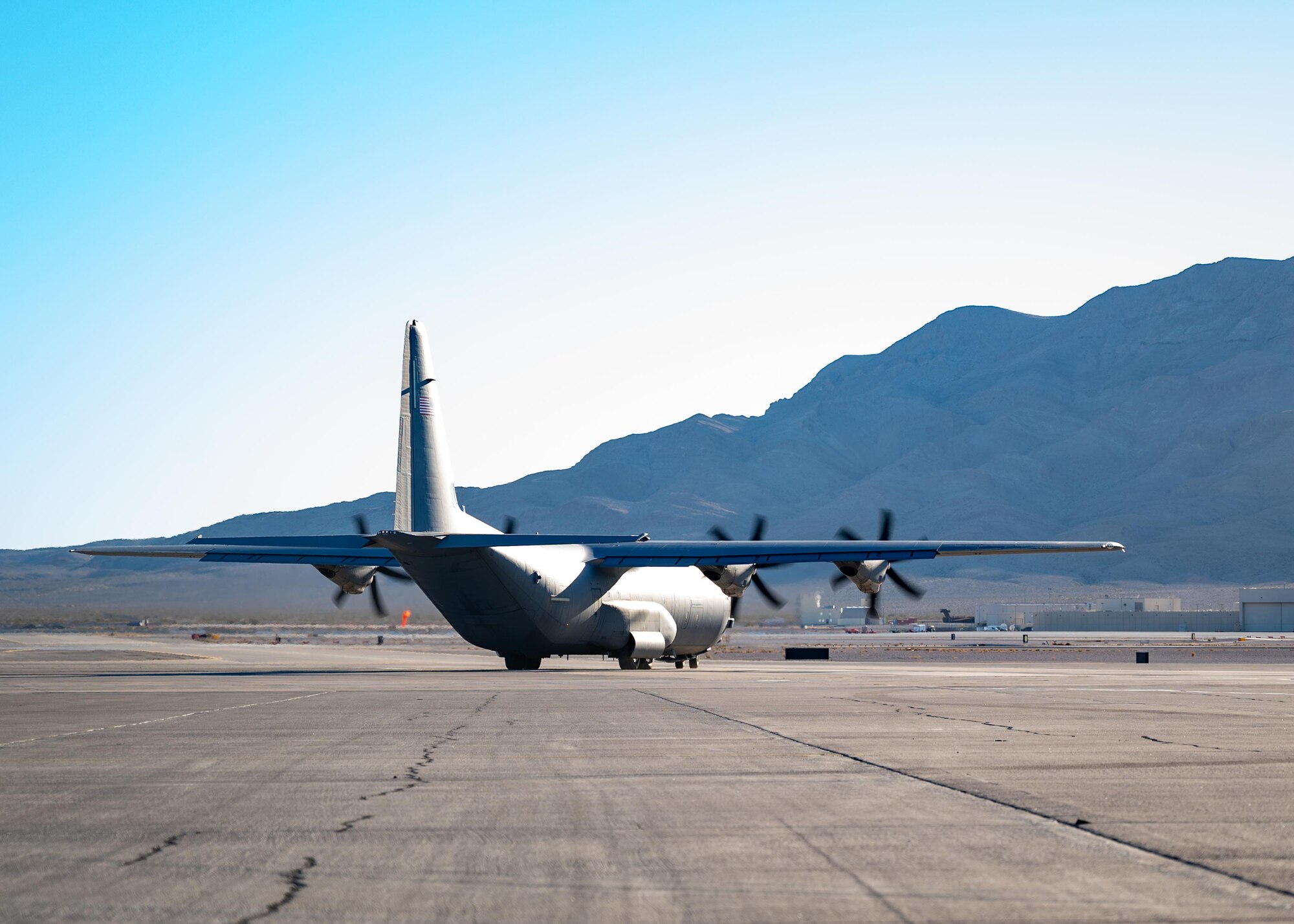 A C-130 Hercules taxis on the runway.