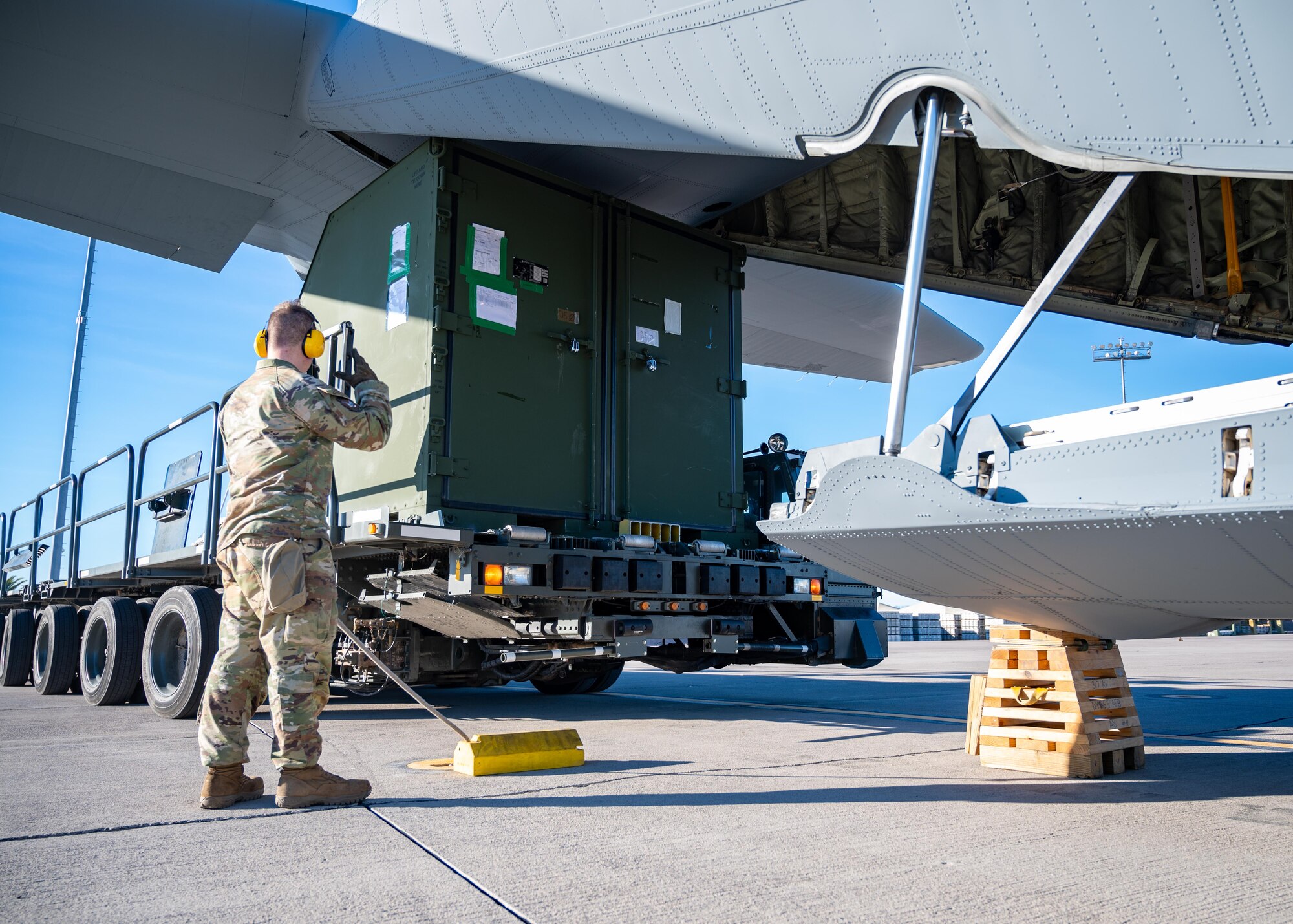 An Airman loads cargo onto a C-130 Hercules.