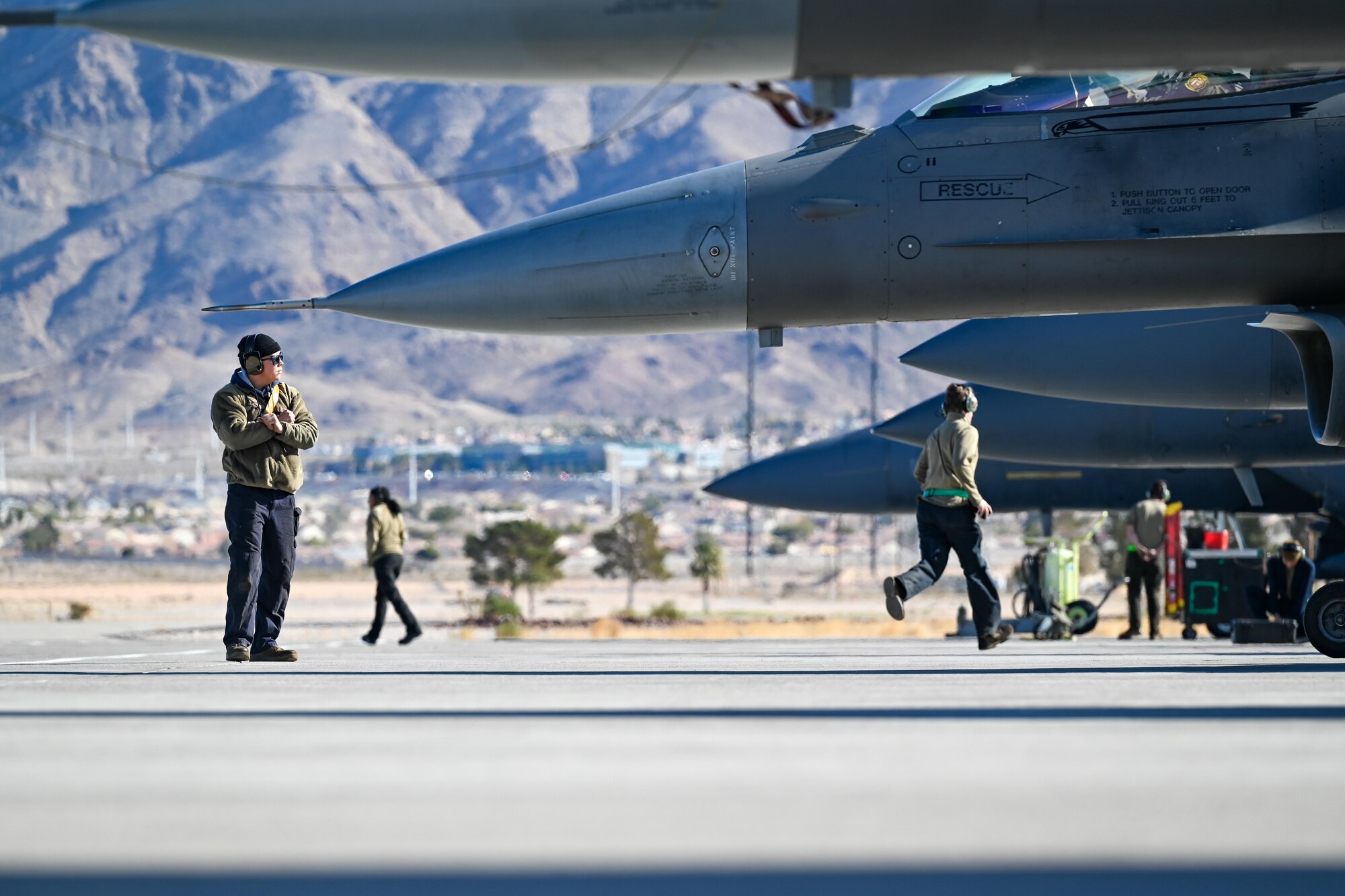 Crew chief airmen marshal their aircraft prior to launch.